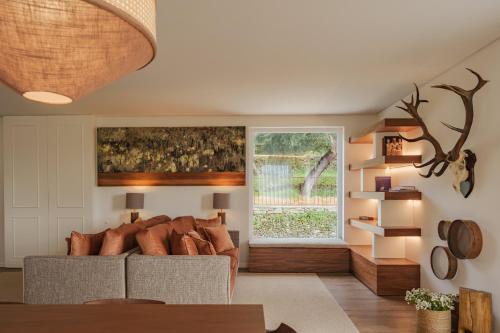 a living room with a couch and a window at Feel Discovery Casal do Temporao Douro Valley in Peso da Régua
