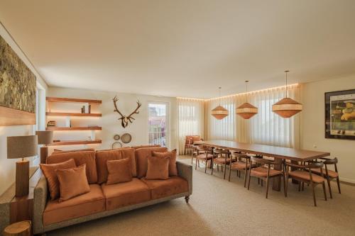 a living room with a couch and a table and chairs at Feel Discovery Casal do Temporao Douro Valley in Peso da Régua