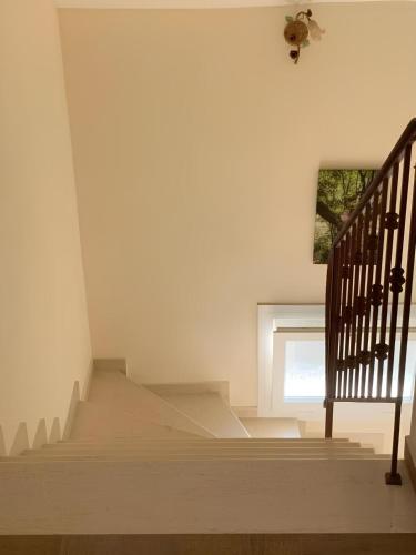 a staircase in a house with a window at Rodon Apartment with Great View, Sauna and Jacuzzi in Litochoro