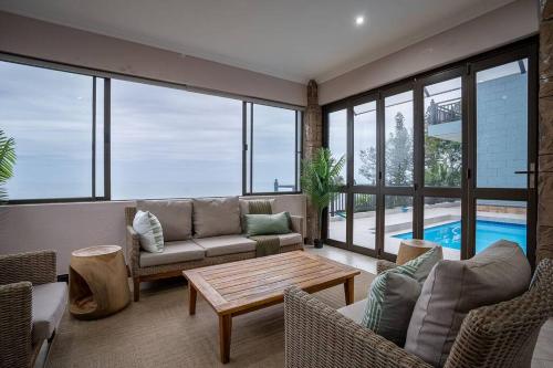 a living room with a couch and a table at Entire Home in Sheffield Beach in Sheffield Beach