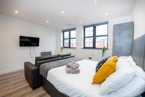 a bedroom with a large bed with yellow pillows at Studio Apartment in Liverpool City Centre in Liverpool