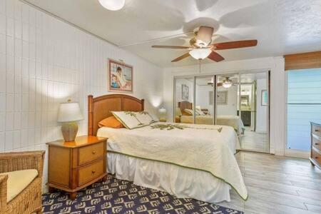 Schlafzimmer mit einem Bett und einem Deckenventilator in der Unterkunft Beautiful Beachfront Condo in Laie