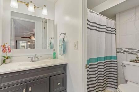 a bathroom with a sink and a toilet and a shower at Beautiful Beachfront Condo in Laie