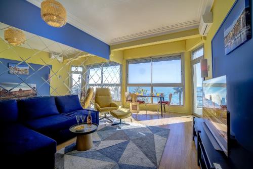 un salon avec un canapé bleu et une table dans l'établissement Maison Bianchi - 187 Promenade des Anglais - Sea view, à Nice