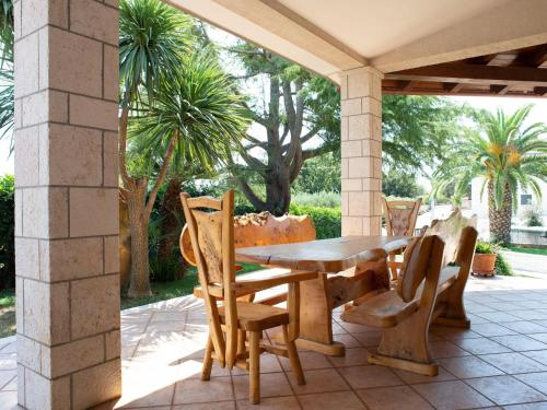 een houten tafel en stoelen op een patio bij Holiday rental Tenuta Masiedd 1 Cisternino in Cisternino