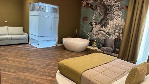 a room with a bed and a bath tub in it at PALAZZO CHINIAL in Torre del Greco