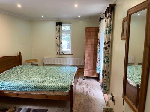 a bedroom with two beds and a window at Llangollen cosy apartment in Llangollen
