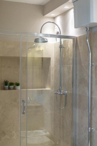 a shower with a glass door in a bathroom at La piccola Severina in Cortona