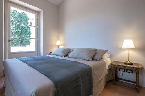 a bedroom with a bed and a window at La piccola Severina in Cortona