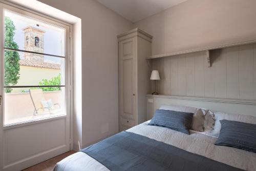 a bedroom with a large bed and a window at La piccola Severina in Cortona