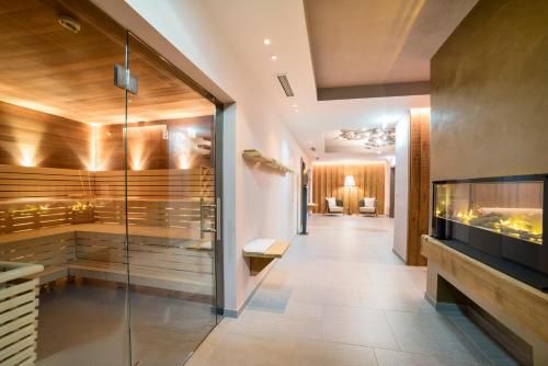 a large hallway with a room with a aquarium at Wellnesshotel Eggerwirt in Sankt Michael im Lungau