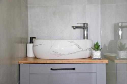 a white sink on a counter in a bathroom at Apartman Lucana in Tribunj