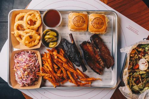 a tray of food with different types of food on a table at JA Palm Tree Court, Dubai in Dubai