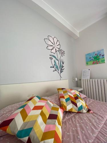 a bedroom with a bed with a flower on the wall at MAF B&B in Cupello
