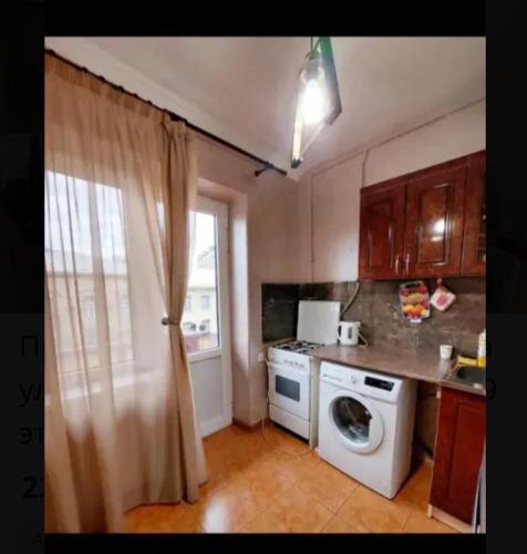a kitchen with a washing machine and a window at Квартира в центре Еревана in Yerevan