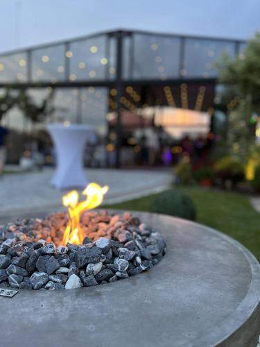a fire pit on a table with rocks at Kovač Residence in Zrenjanin