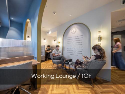 a group of people sitting in chairs in a waiting room at Estinate Hotel Naha in Naha