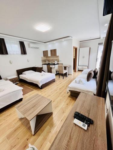 a large living room with two beds and a table at Kovač Residence in Zrenjanin