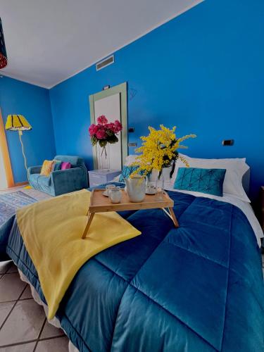 a blue bedroom with a bed with a table on it at Casa di Giove room in Pompei