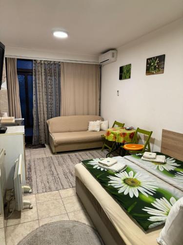 a living room with two beds and a couch at Nela Apartmani in Niš