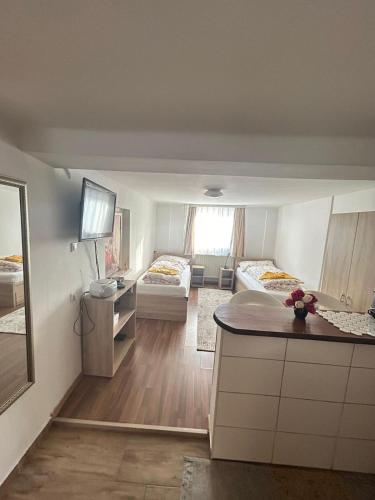 a room with two beds and a kitchen with a counter at Apartment don bosco in Graz