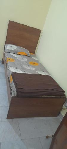 a large wooden bed sitting in a room at Al Amoodi Furnished Apartments in Hyderabad