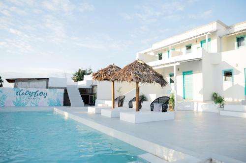 a resort with a swimming pool and a hotel at Woywoy Paradise in Bira