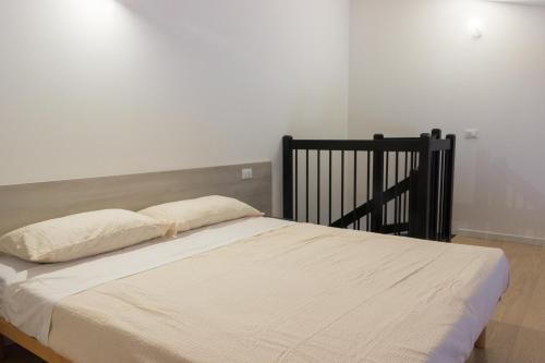 a bed with two pillows on it in a bedroom at Agriturismo Ca' Manzato in Passarella