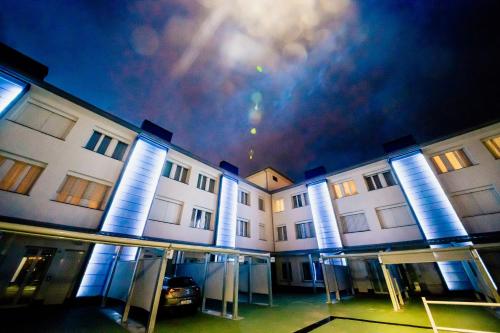a building with a car parked in front of it at Diamante MHotel in Collegno