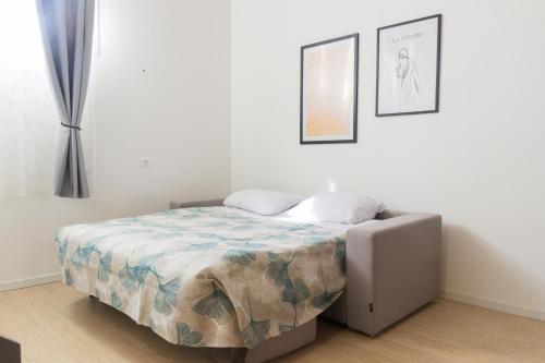 een slaapkamer met een bed in een kamer met 2 foto's bij Agriturismo Ca' Manzato in Passarella