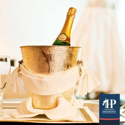 a bottle of champagne in a bucket on a table at Hotel Presidente in Santiago