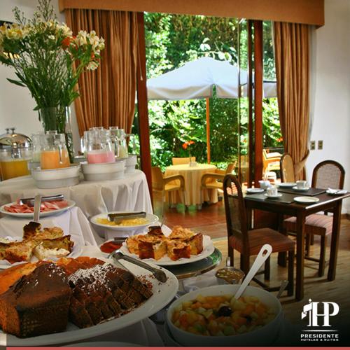 a table full of food with plates of food at Hotel Presidente in Santiago