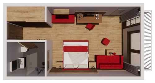 a room with a red couch and a bed at Ferienclub Bellevue am See in Walchsee
