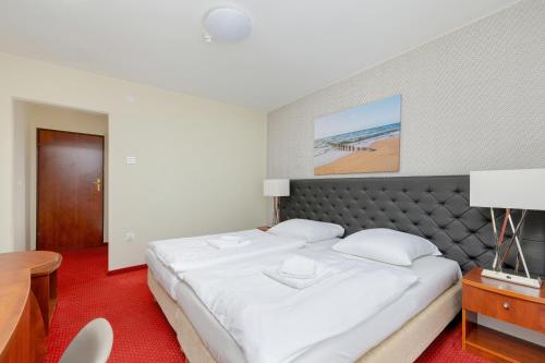 Ένα ή περισσότερα κρεβάτια σε δωμάτιο στο Gryf Resort Międzywodzie