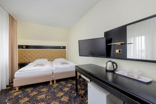 Ένα ή περισσότερα κρεβάτια σε δωμάτιο στο Gryf Resort Międzywodzie