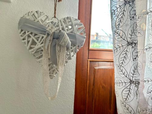 a heart shaped object is hanging on a wall at In campagna in Besozzo