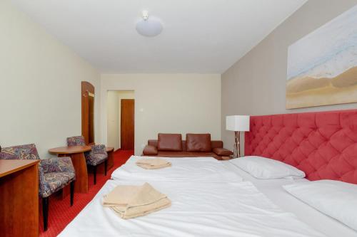 Ένα ή περισσότερα κρεβάτια σε δωμάτιο στο Gryf Resort Międzywodzie