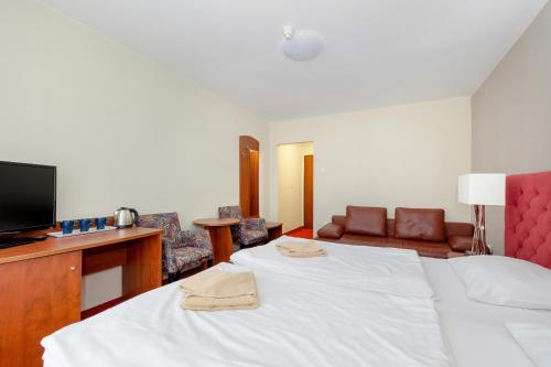 Ένα ή περισσότερα κρεβάτια σε δωμάτιο στο Gryf Resort Międzywodzie