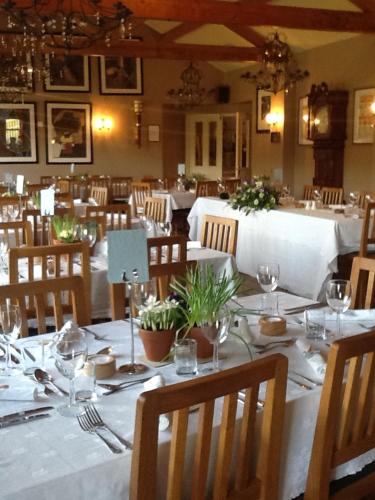 a dining room with a table with plates and glasses at The Charles Bathurst Inn in Richmond