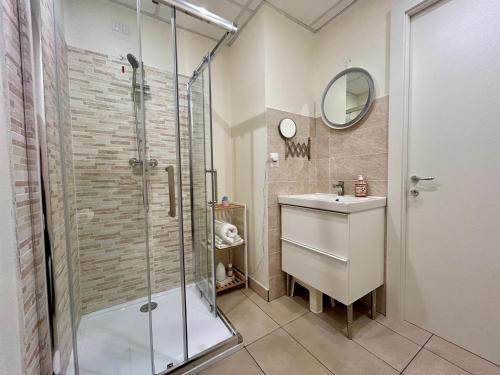 a bathroom with a shower and a sink and a mirror at In campagna in Besozzo
