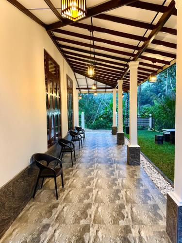 a row of chairs are lined up on a patio at Serene Bliss Villa in Unawatuna
