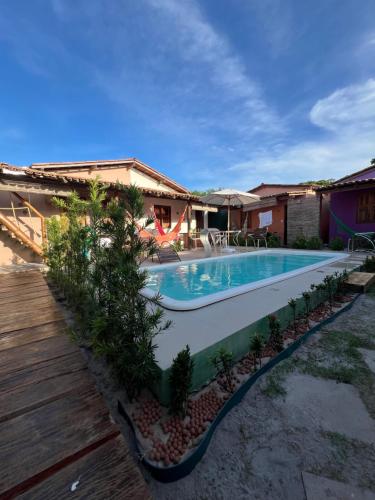 a swimming pool in the backyard of a house at Casa Recanto - Villa Uryah in Caraíva