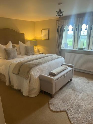 a bedroom with a large bed and a window at Church Gate Farm in Harrogate