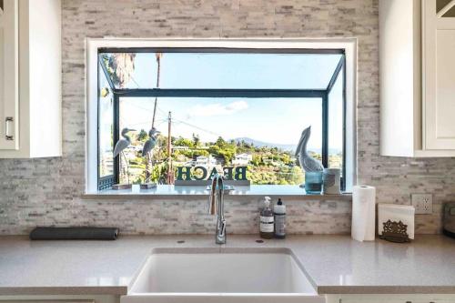 a kitchen counter with a sink and a window at Summer Beach House in Summerland