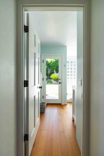 a hallway with a door open to a room at Summer Beach House in Summerland