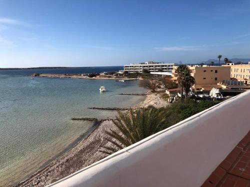 a view of a beach from a balcony at Apartamentos Sabina Playa in La Savina