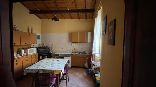 a small kitchen with a table and a counter top at Peppina Home in Ghilarza