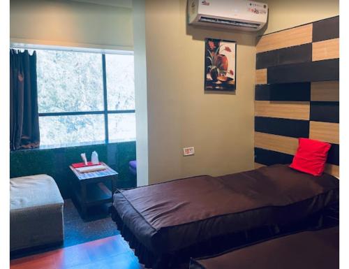 1 dormitorio con cama y ventana en Hotel Hill Top, Bokaro, en Bokāro
