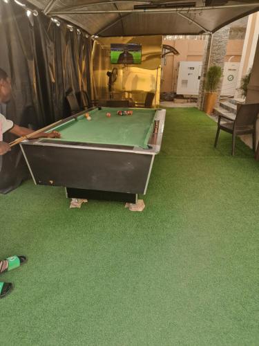 a man standing next to a pool table in a tent at STAR DIAMOND VIEW LOUNGE & SUITE 