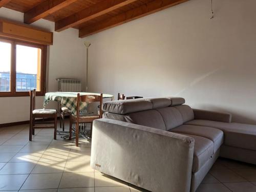 a living room with a couch and a table at Mansarda Raffaello in Seregno